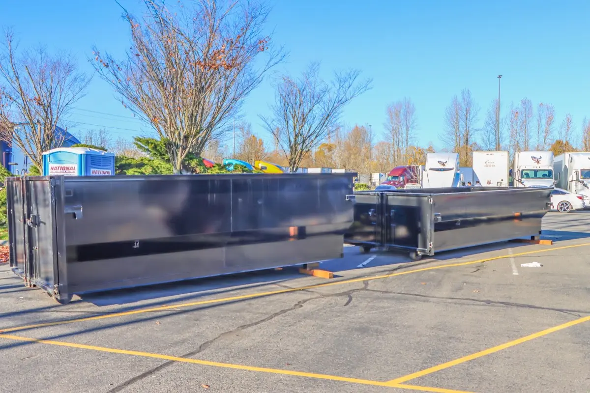 Professional dumpster rental service with roll-off container on residential driveway in Sanibel